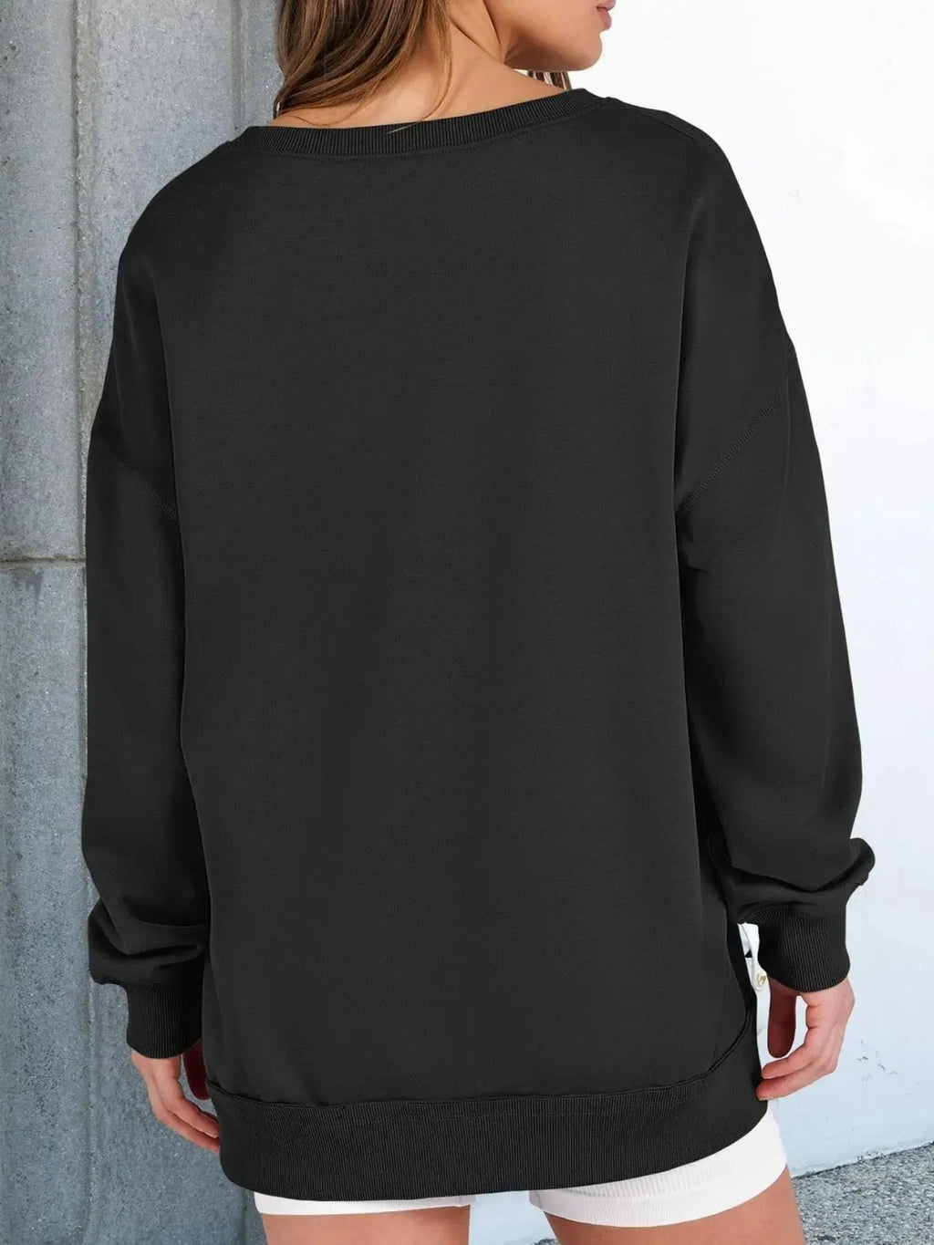 Notched long sleeve oversized sweatshirt by Belle Bijouix in black with ribbed cuffs and hem.