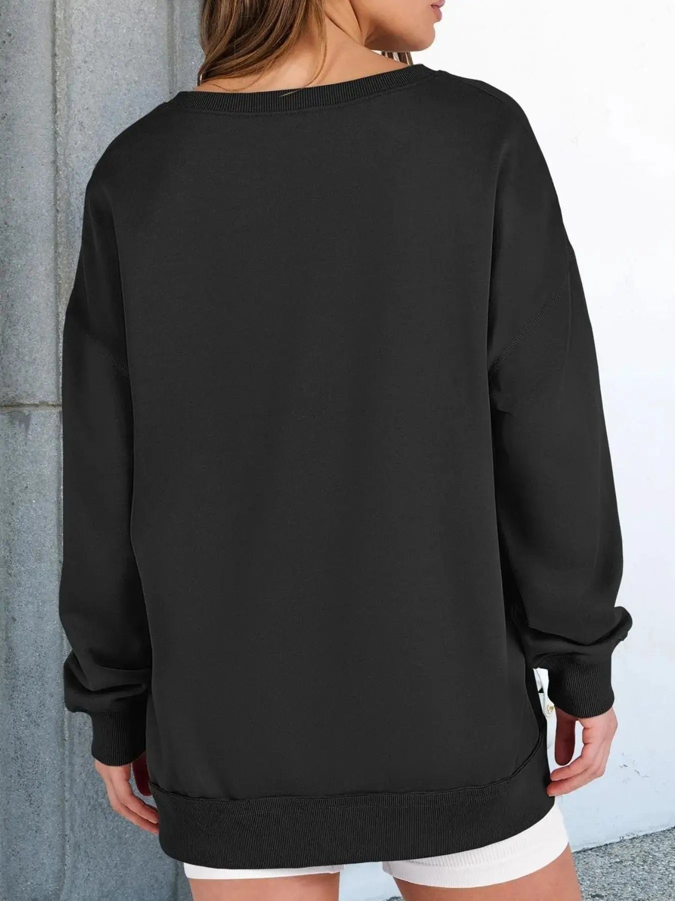 Notched long sleeve oversized sweatshirt by Belle Bijouix in black with ribbed cuffs and hem.