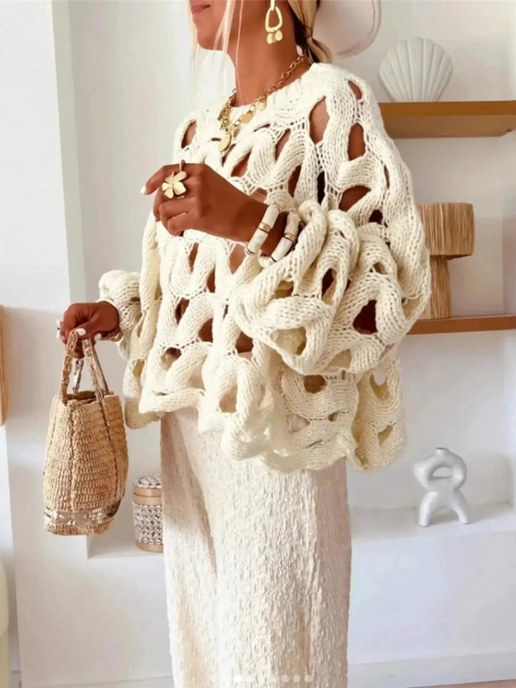 Chunky cable-knit hollow-out sweater in white with open-knit cutouts