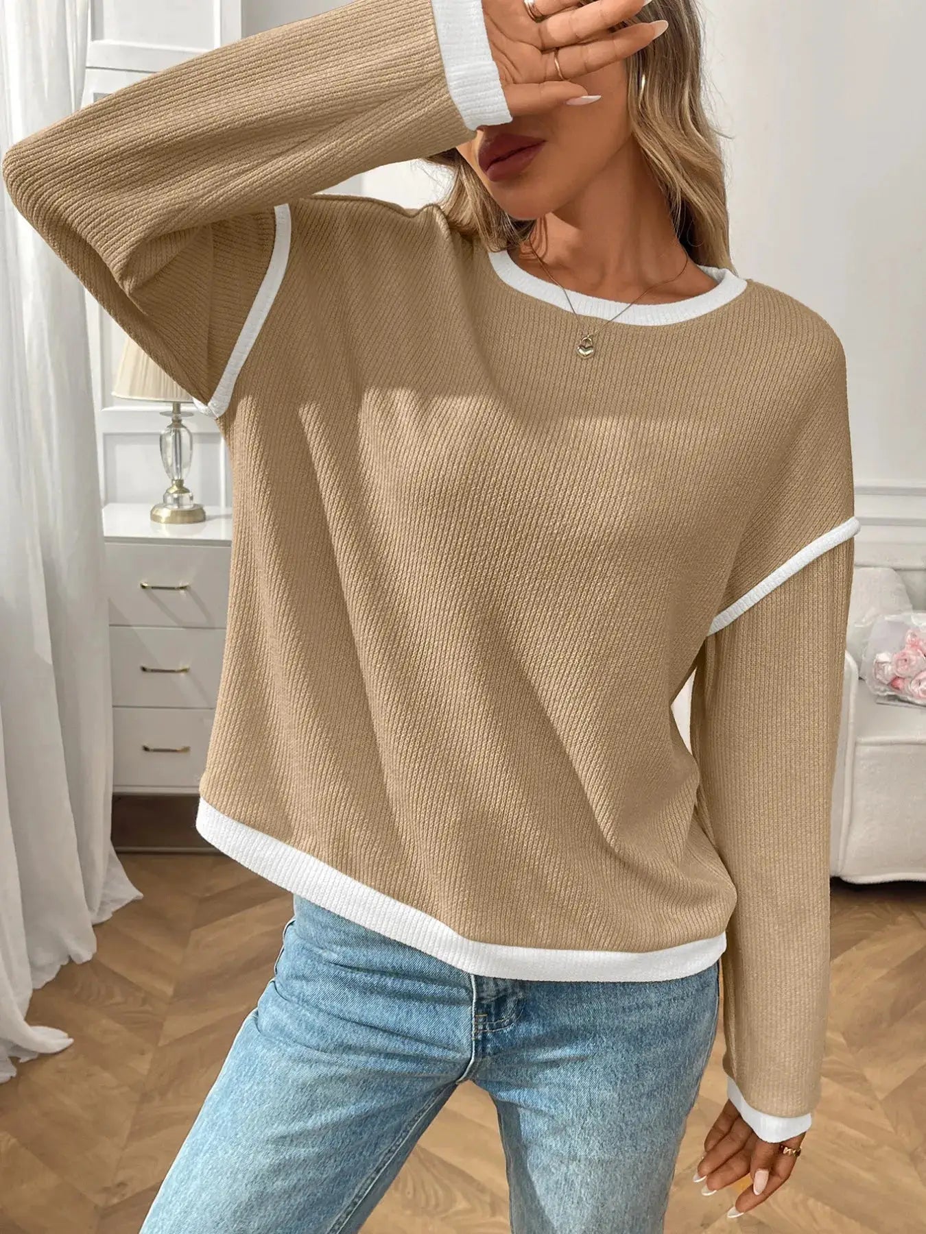 Ribbed contrast-trim long sleeve top in beige with white neckline, cuffs, and hem