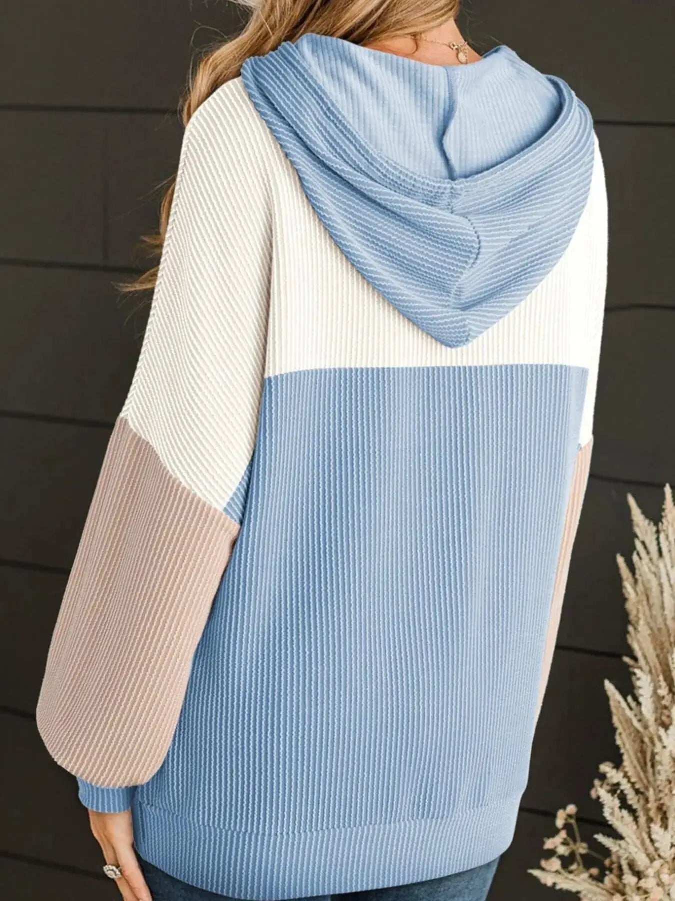 Drawstring color-block long sleeve hoodie top with blue, white and beige ribbed knit panels.