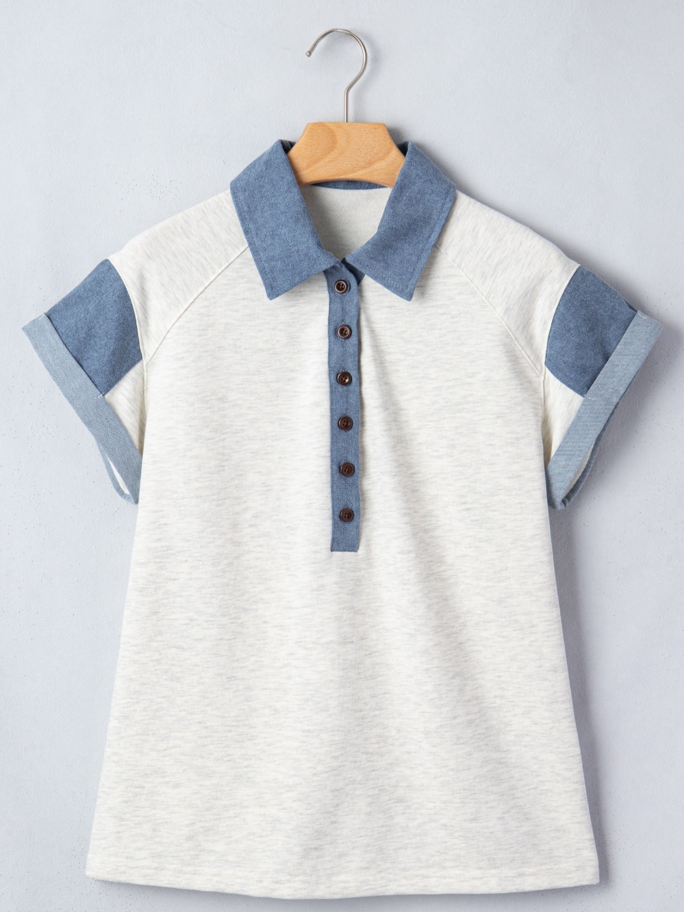 Contrast Trim Button Detail Top by Trendsi; cream body with blue denim-style collar placket and cuffs on a hanger