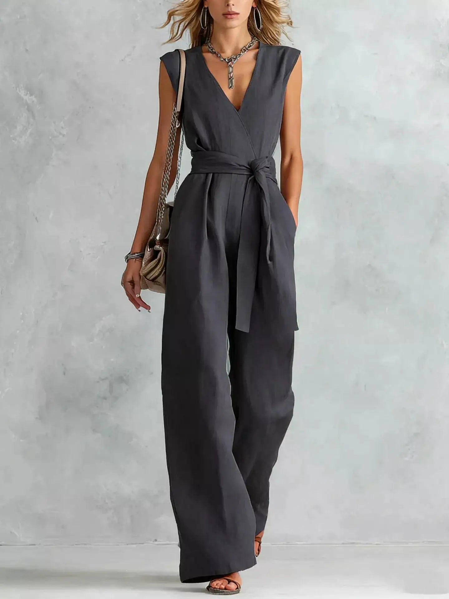 Sleeveless wide-leg jumpsuit by Belle Bijouix in charcoal gray with a tied waist belt