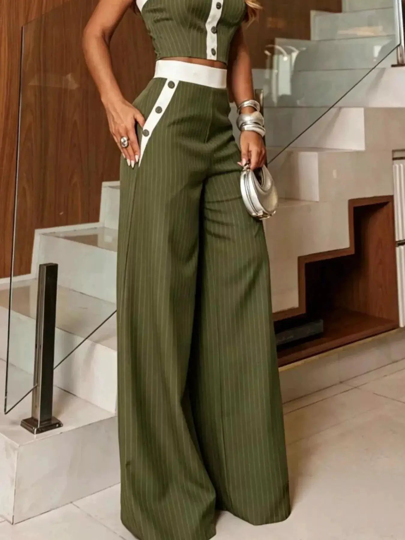 Striped olive-green strapless crop top and wide-leg pants set with white waist panel and button stripe.