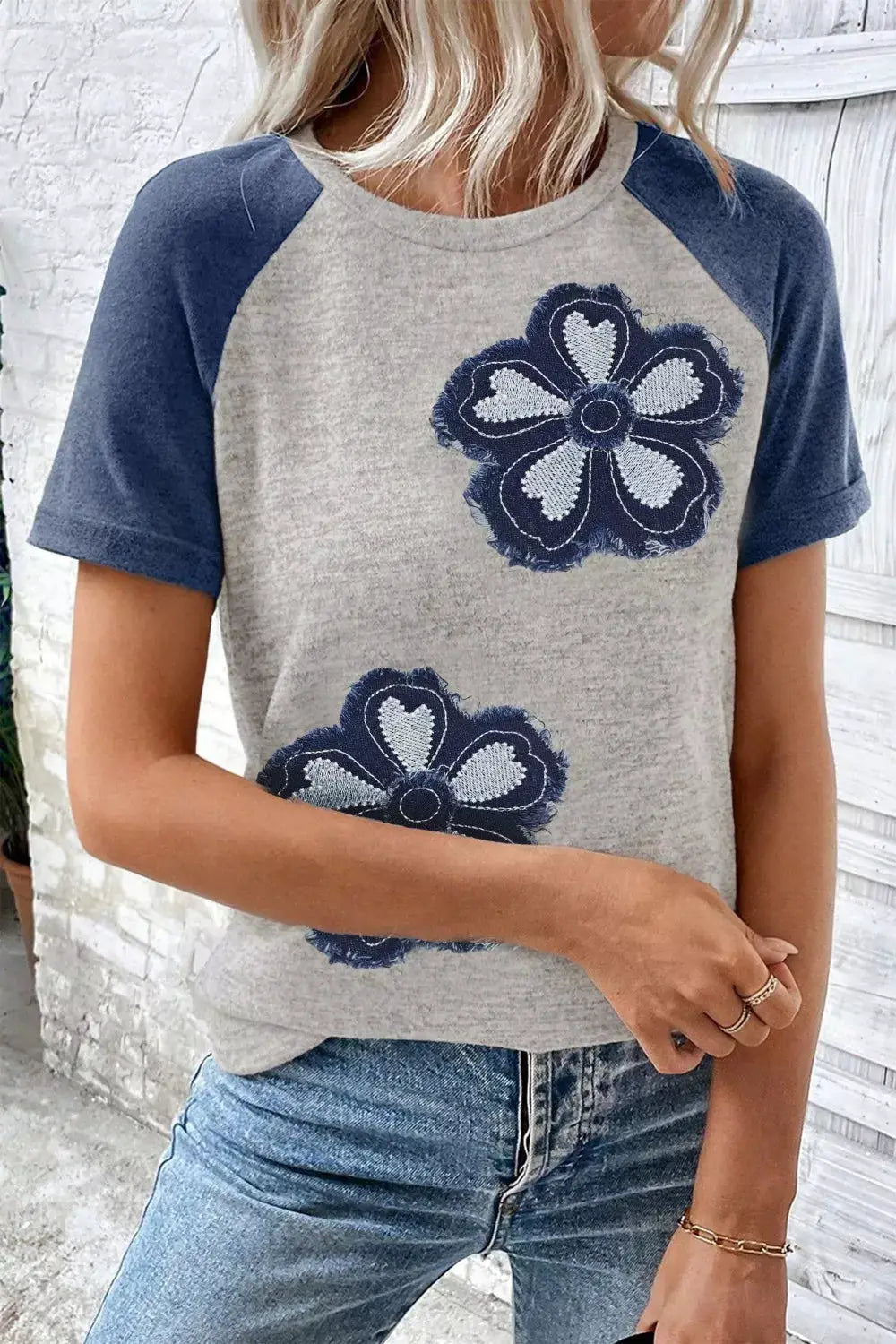 Floral Raglan Sleeve T-Shirt in heather gray with navy sleeves and two large embroidered blue flowers on the front