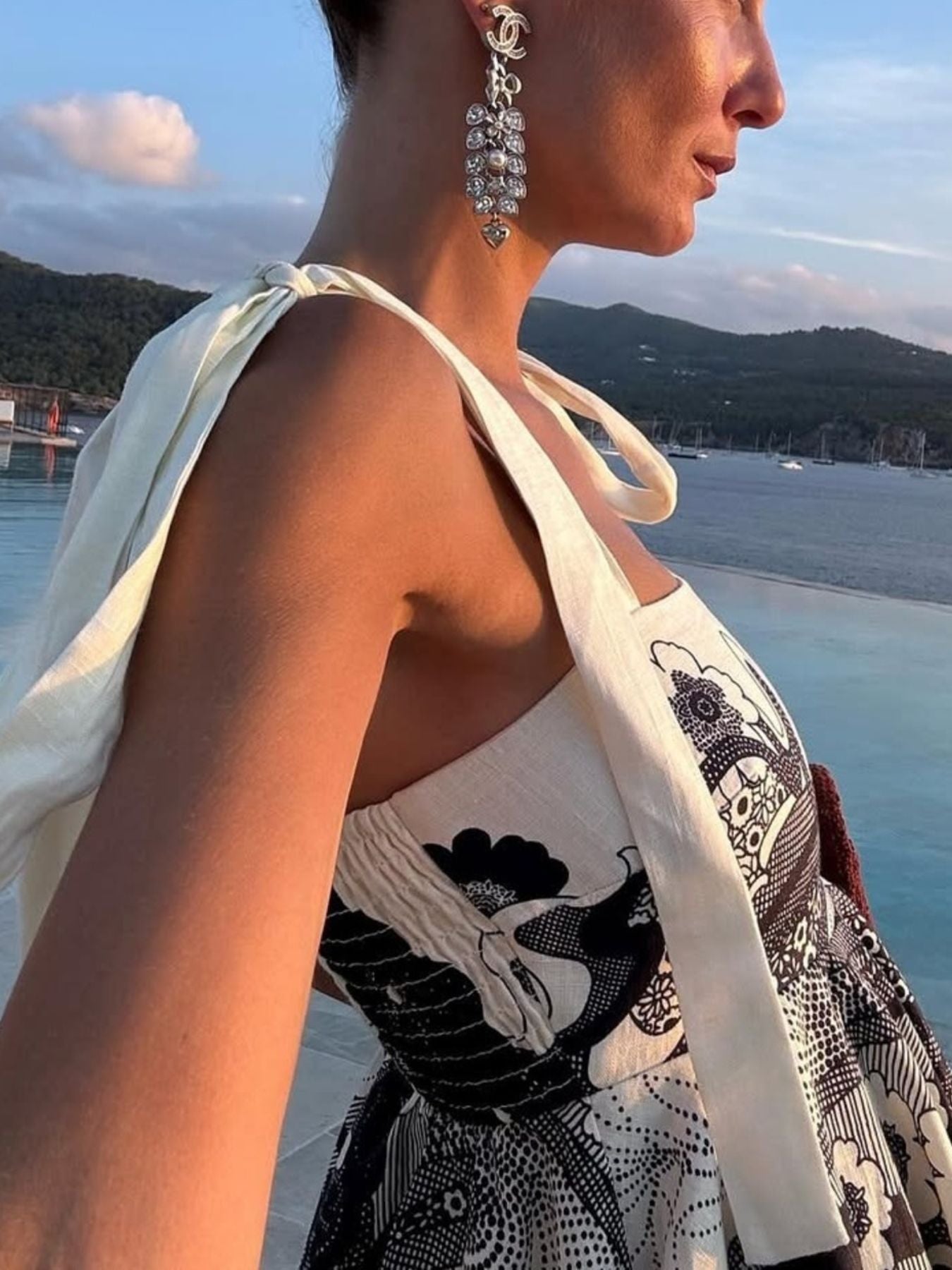 Printed tie-shoulder mini dress in cream with black print; smocked waist, pocketed