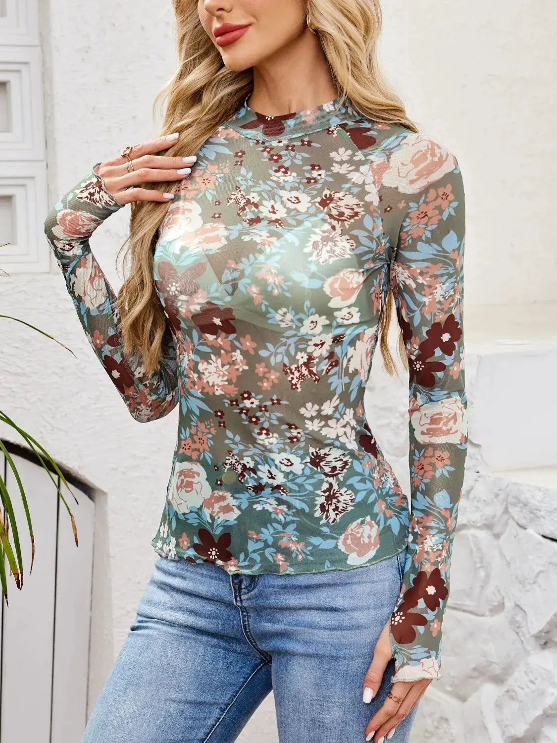 Floral mock-neck long-sleeve top; teal base with pink and ivory flowers.