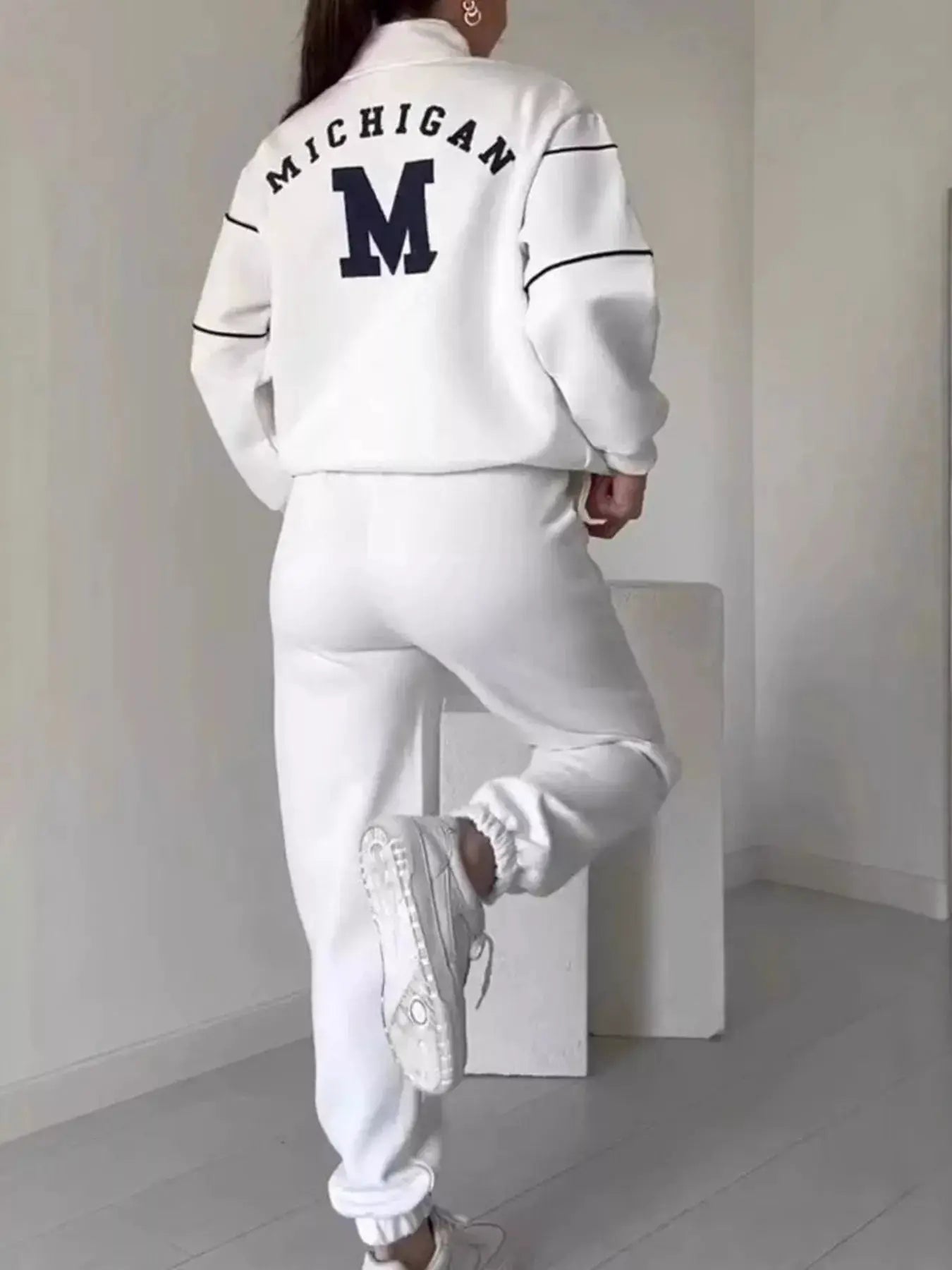 Plus-size white striped quarter-zip top and pants set with black sleeve piping and Michigan M logo
