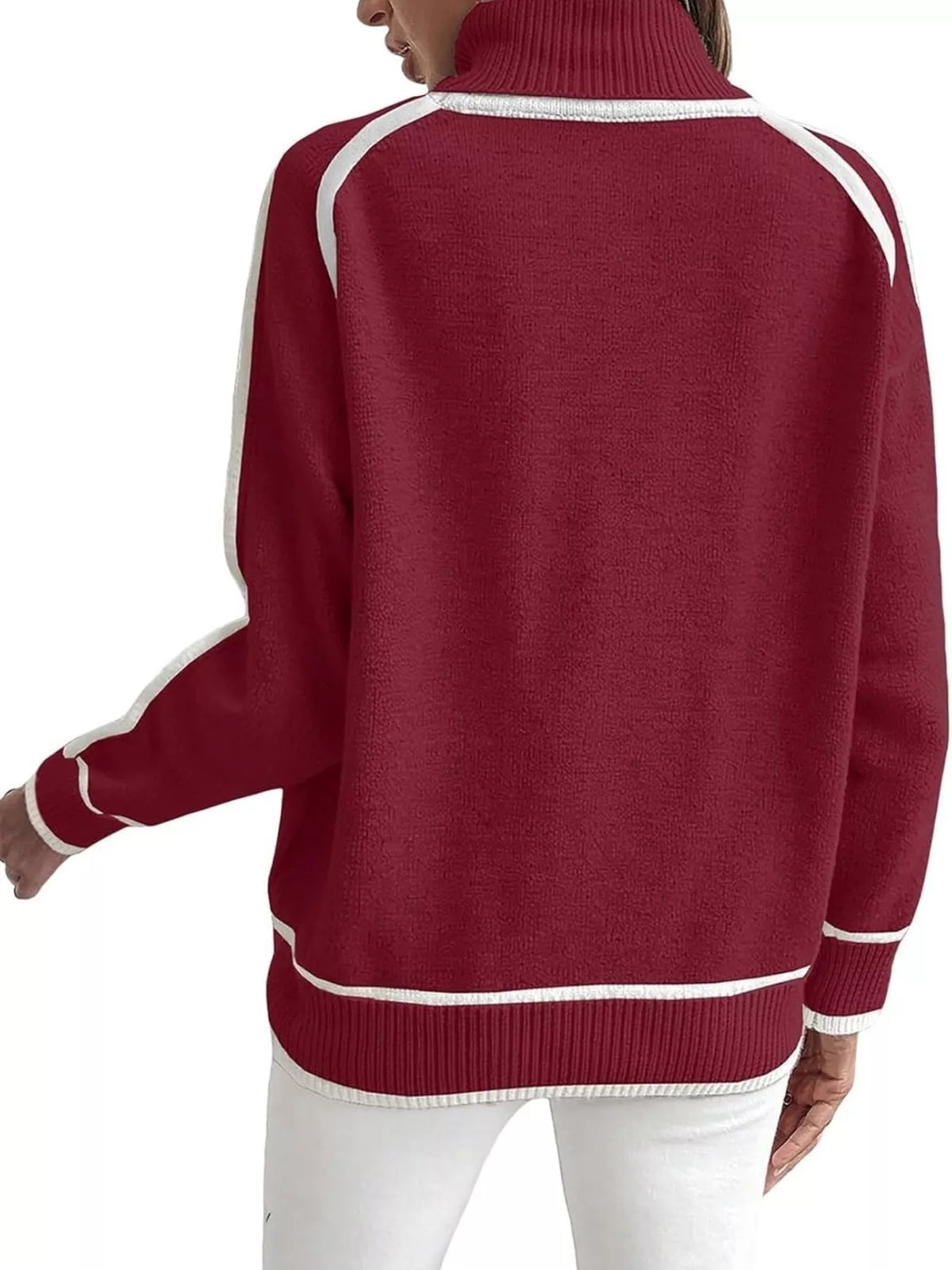 Back view of red turtleneck sweater with white contrast trim and ribbed hem