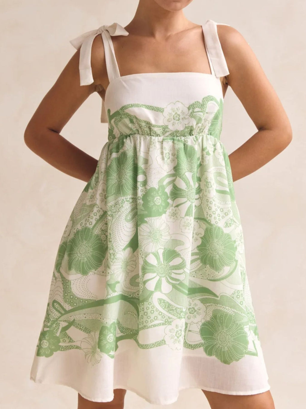 Printed Tie Shoulder Mini Dress in white and green floral print with tie shoulder straps.