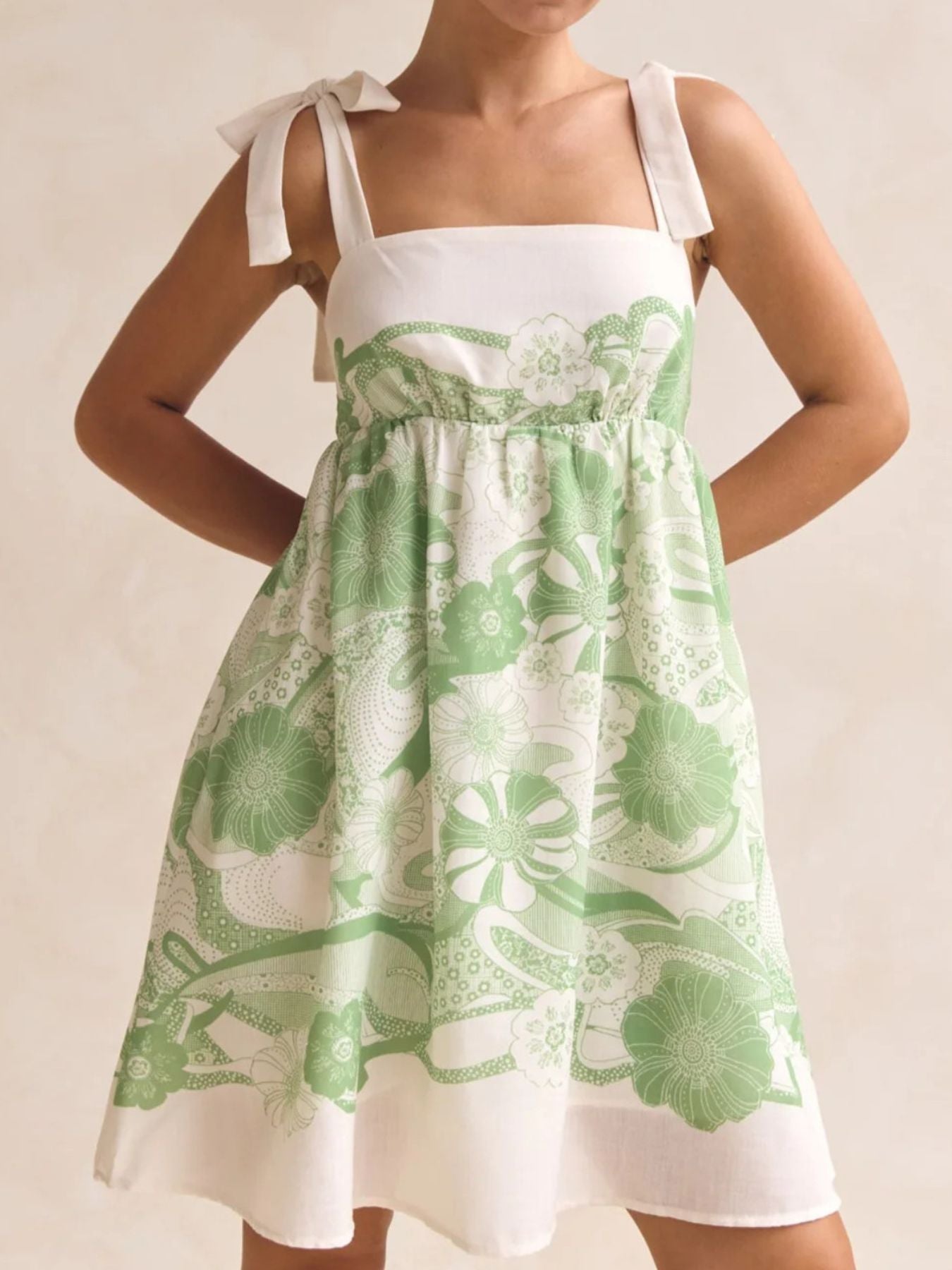 Printed Tie Shoulder Mini Dress in white and green floral print with tie shoulder straps.
