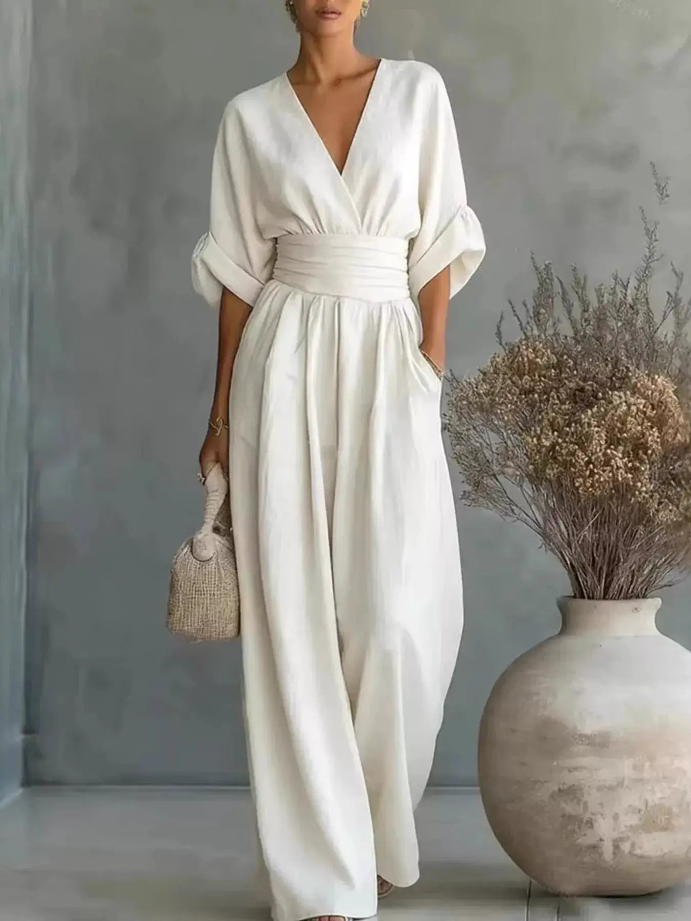 One-piece jumpsuit by Belle Bijouix, white plus-size with V-neck wrap, half sleeves and wide belt