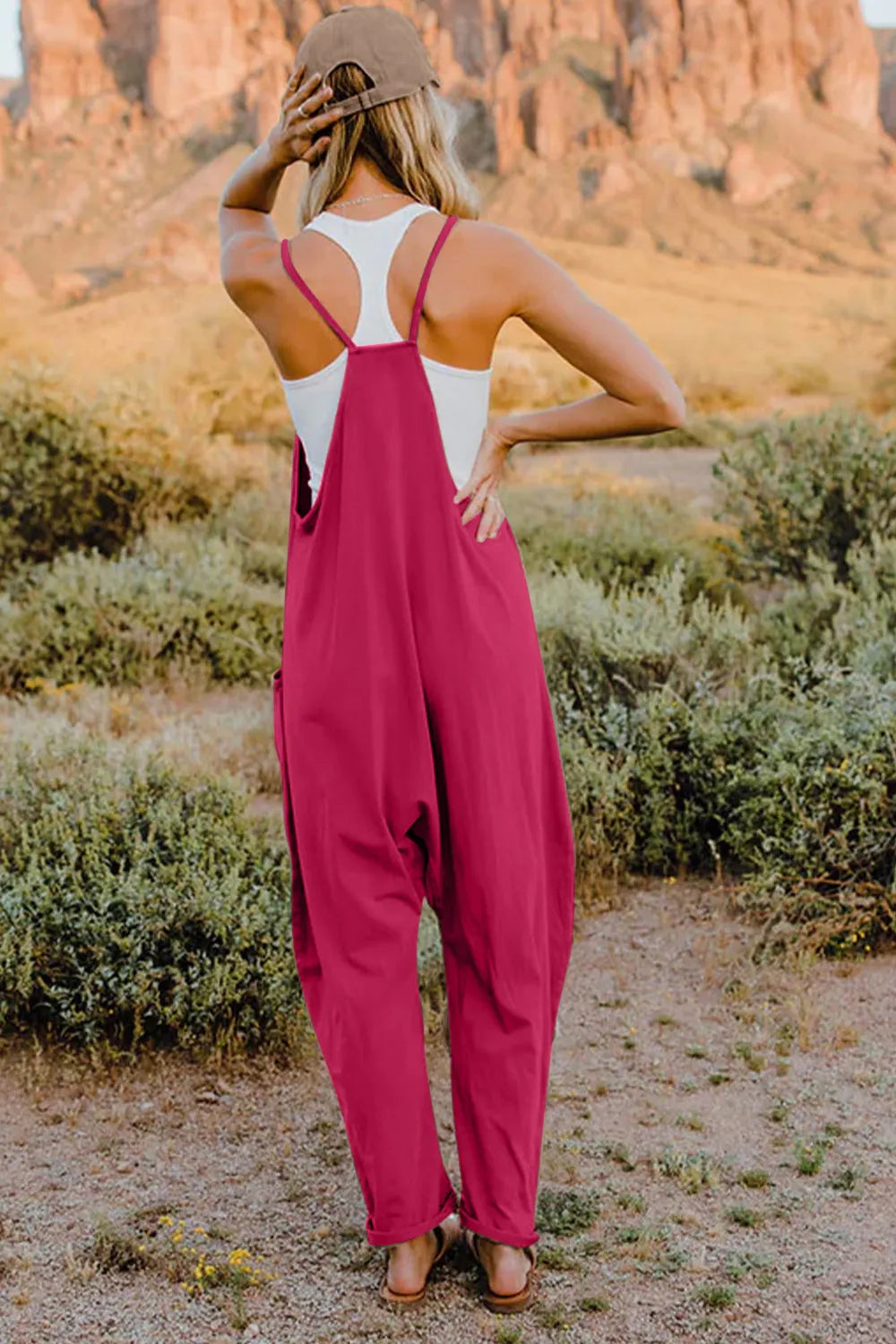 Double Take Full Size V-Neck Sleeveless Jumpsuit with Pockets in magenta, shown from back with white top