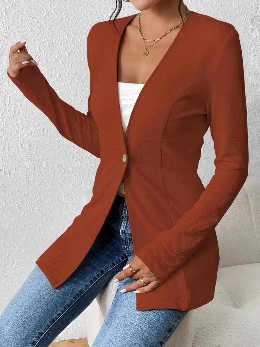 Single-Button Long Sleeve Blazer in rust-orange with open front over white top and jeans