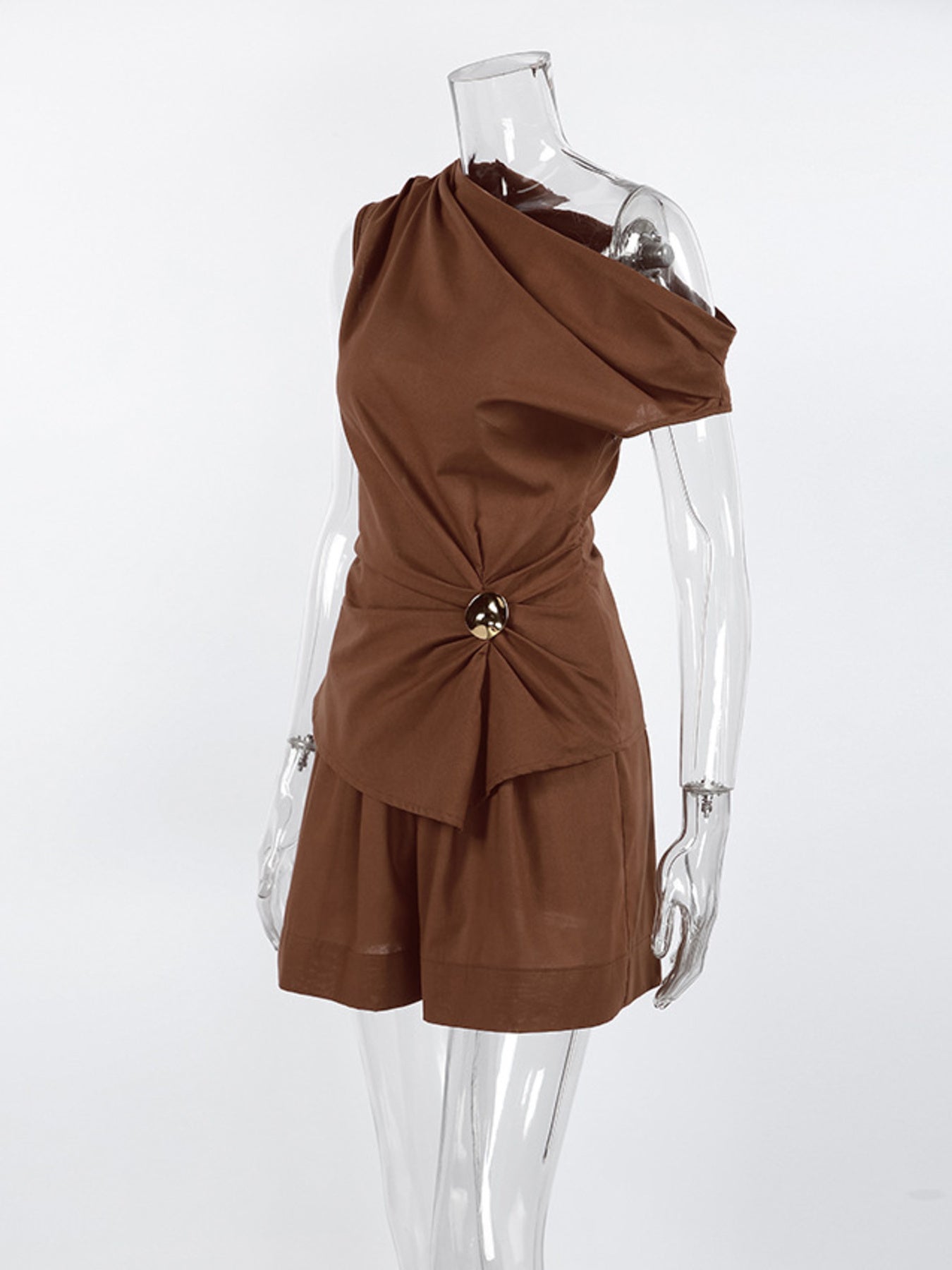 One-Shoulder Top and Shorts Set in brown by Belle Bijouix; ruched, asymmetrical drape with gold ring detail.