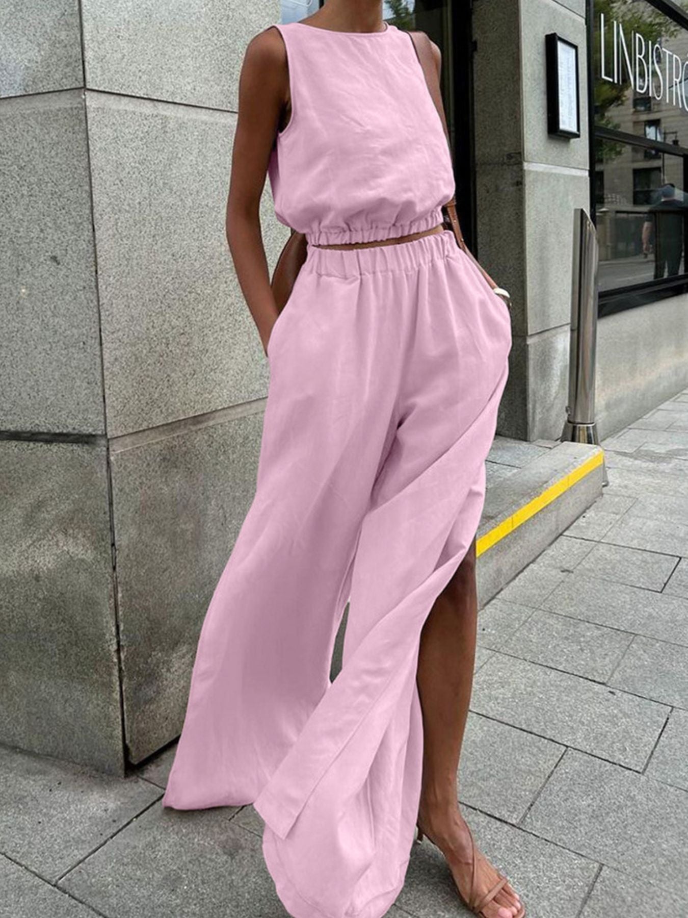 Two-piece pink sleeveless crop top and slit pants set by Belle Bijouix