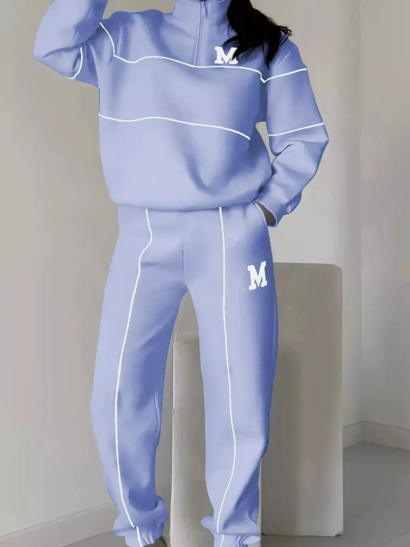 Plus-size lavender two-piece lounge set with white piping; pocketed quarter-zip top and pants