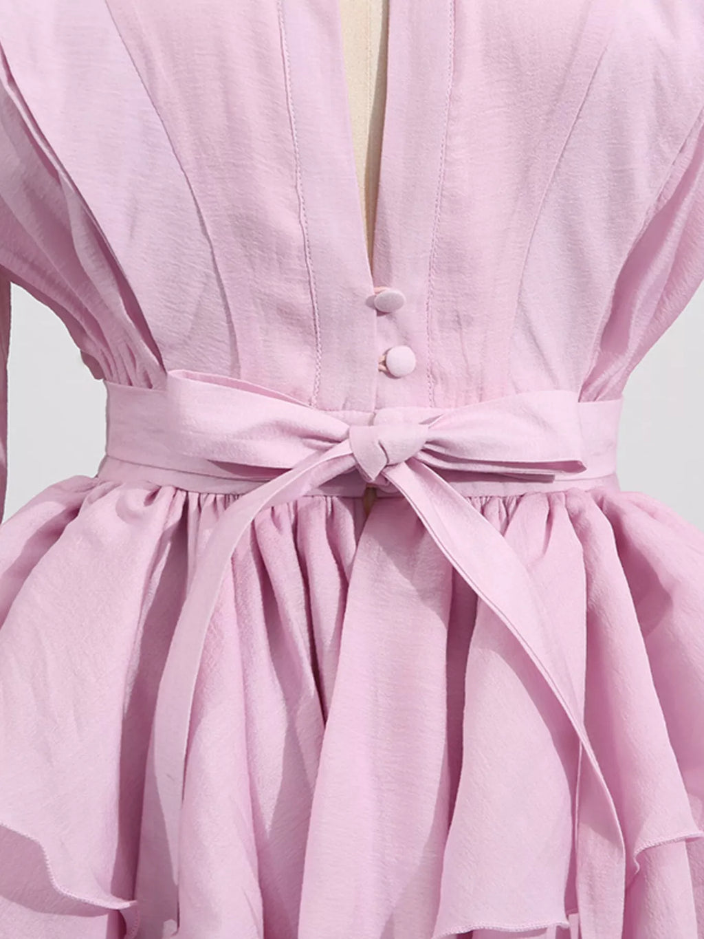 Ruffled Long Sleeve Mini Dress by Belle Bijouix in pink with buttoned front, tiered skirt and belt.