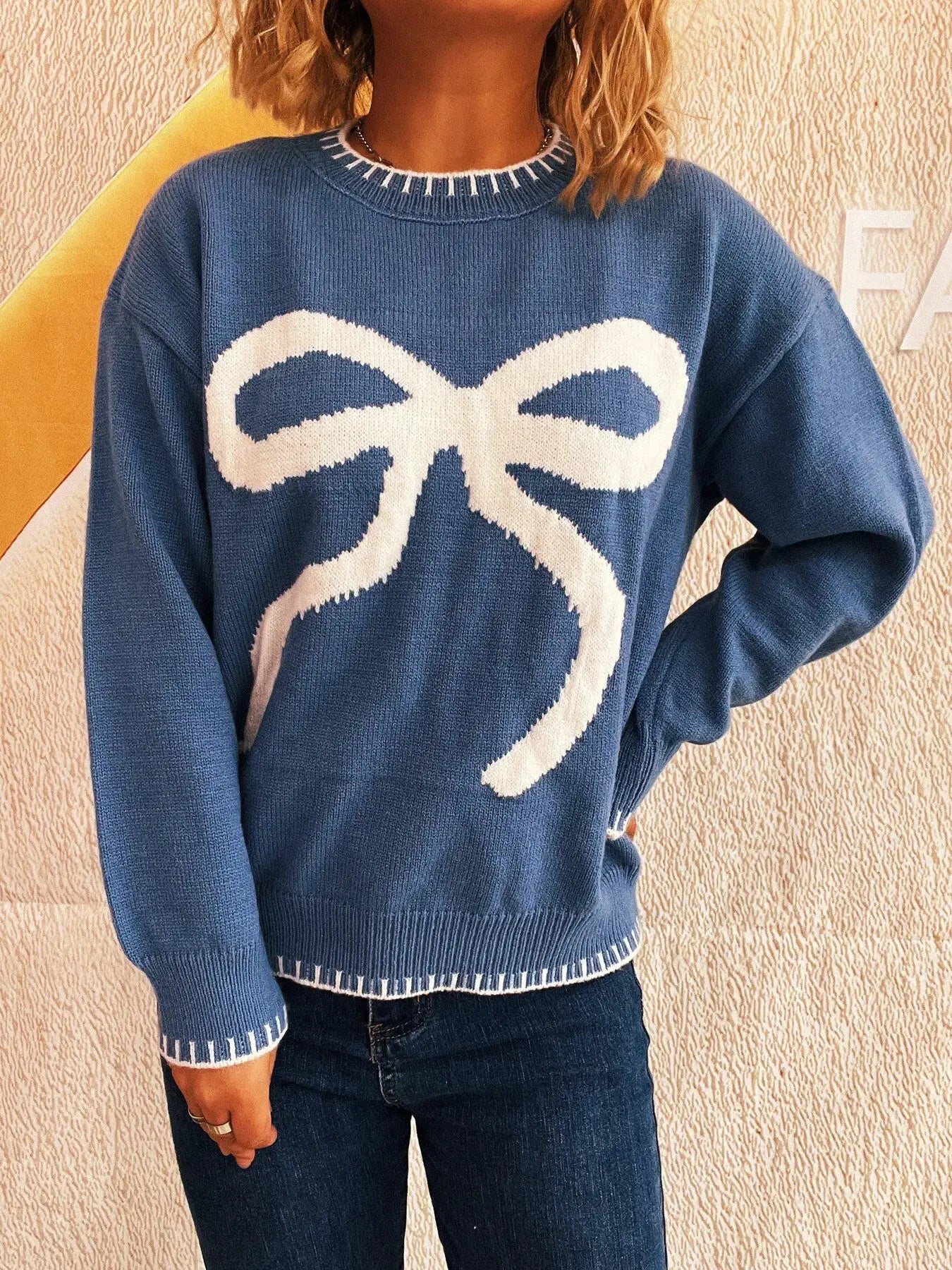 Bow Pattern Round Neck Sweater in blue with a large white bow graphic by Belle Bijouix