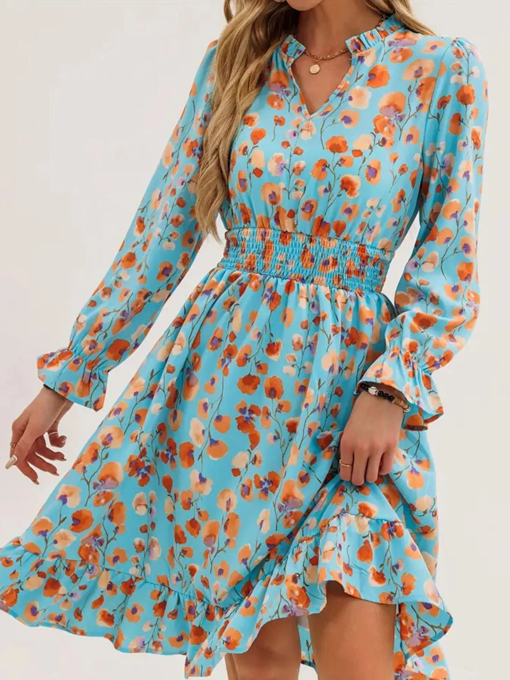 Dress by Belle Bijouix with turquoise floral print, smocked waist and flounce sleeves