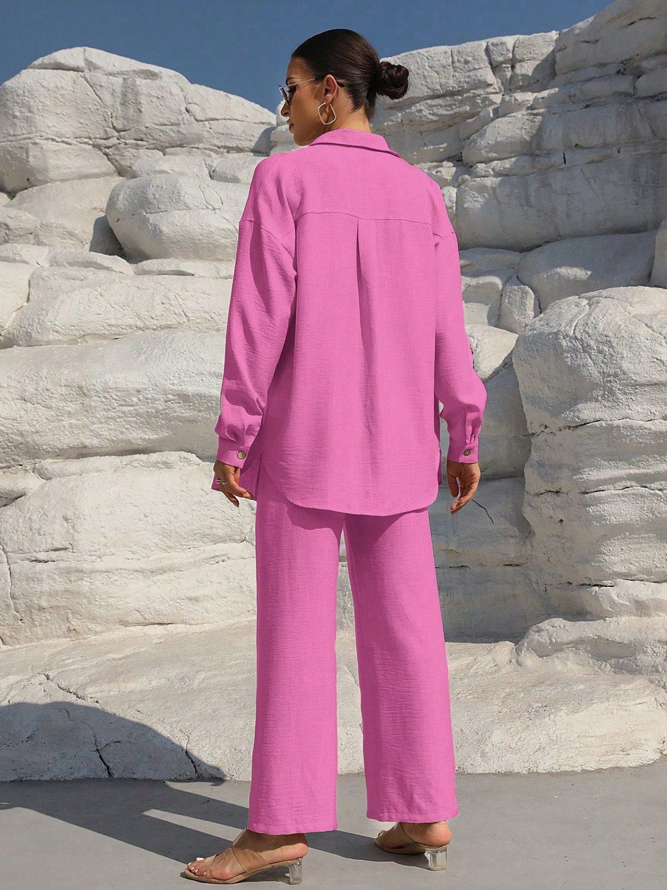 Button Up Long Sleeve Shirt and Pants Set in pink, back view on model wearing matching wide-leg pants by Trendsi.