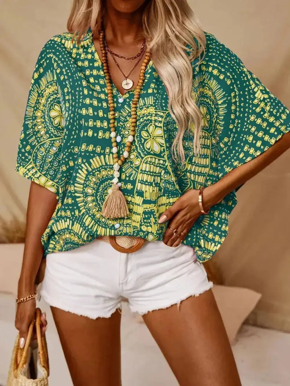 Printed V-Neck Half-Sleeve Top in teal with yellow geometric pattern; sheer, relaxed fit.