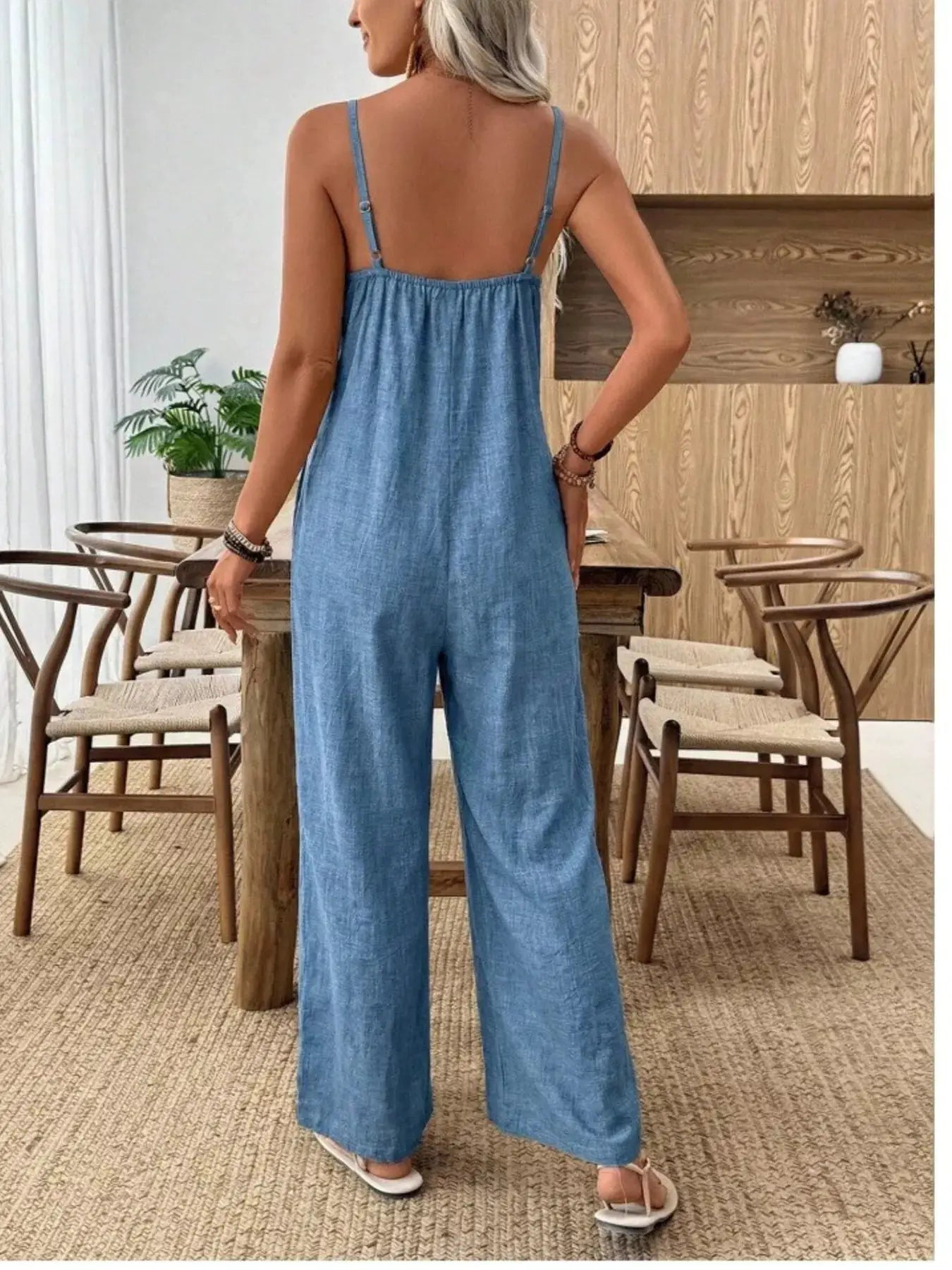 Spaghetti strap wide-leg jumpsuit in blue denim, back view, by Trendsi