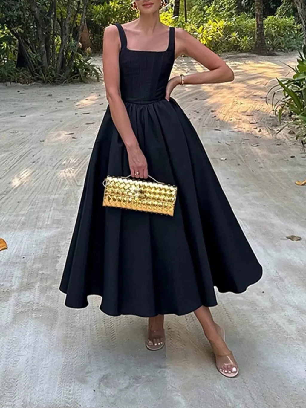 Square Neck A-Line Midi Dress in black with a full skirt and metallic gold clutch