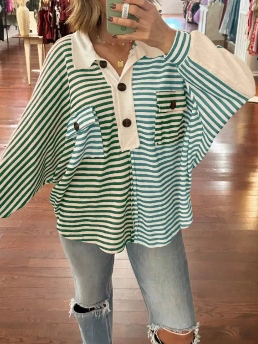 Striped oversized half-button sweatshirt top in green and white with white collar and front placket.