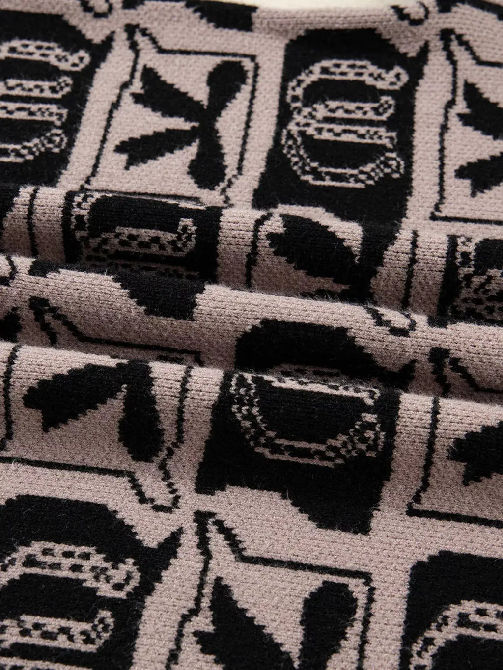 Bows & Horseshoes pattern round-neck sweater by Belle Bijouix with pockets; beige knit with black print.
