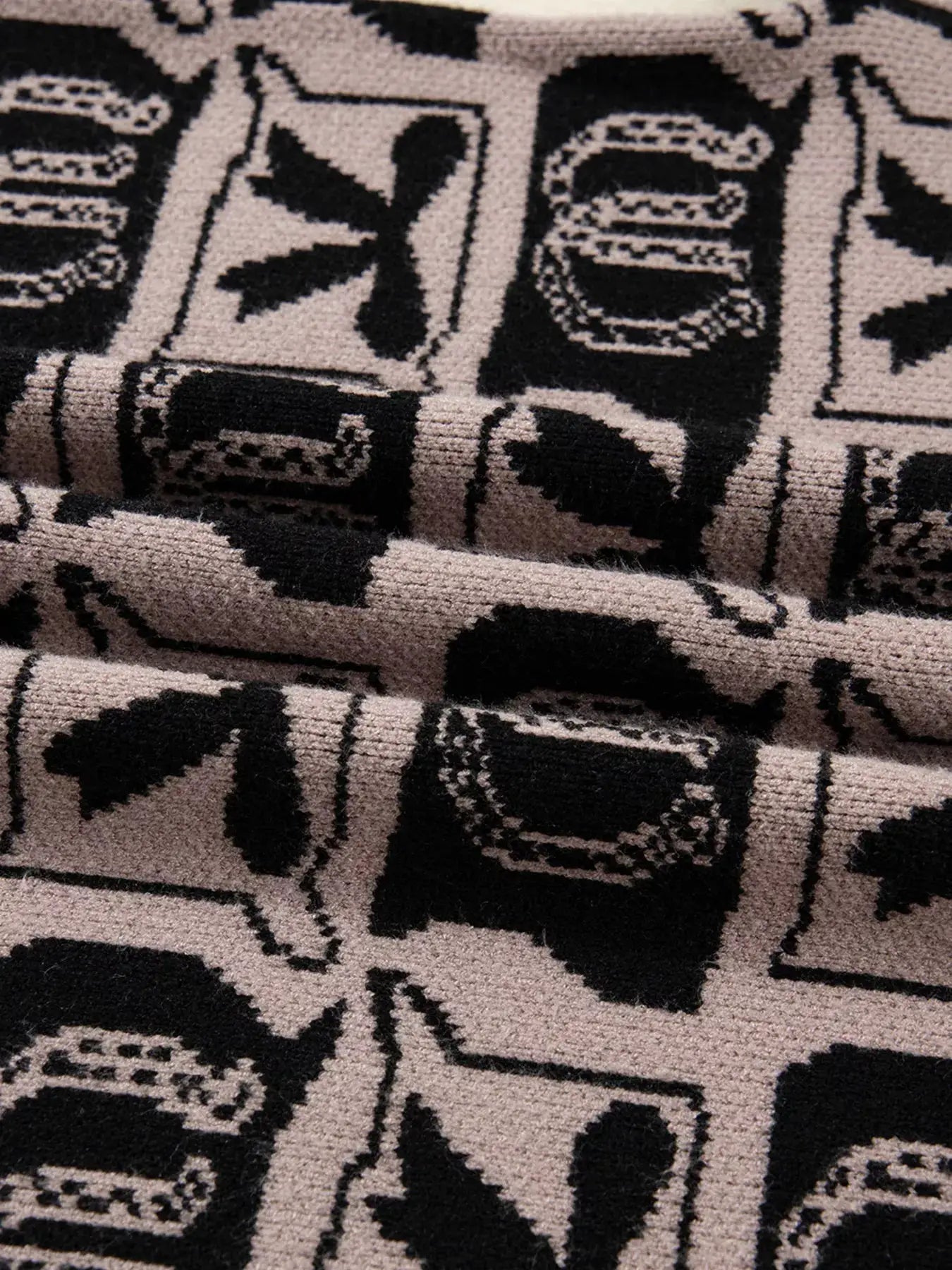 Bows & Horseshoes pattern round-neck sweater by Belle Bijouix with pockets; beige knit with black print.