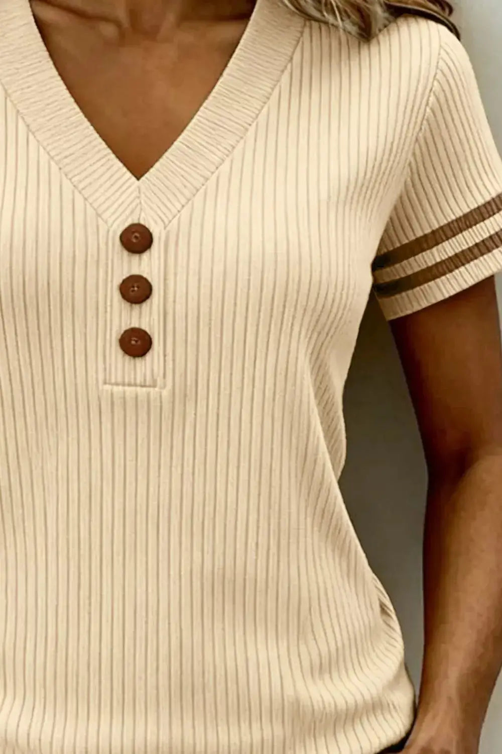 Ribbed V-Neck Knit Top in beige with decorative brown buttons and striped sleeve cuffs