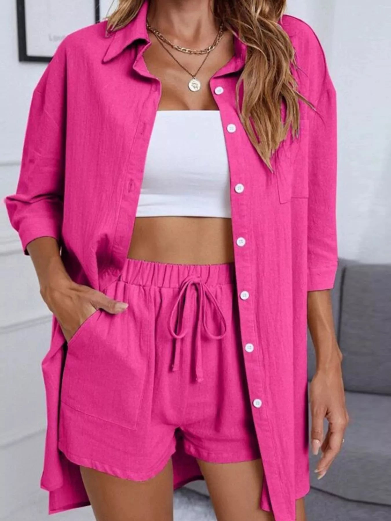 Button-down shirt and shorts set in bright pink with a white crop top.