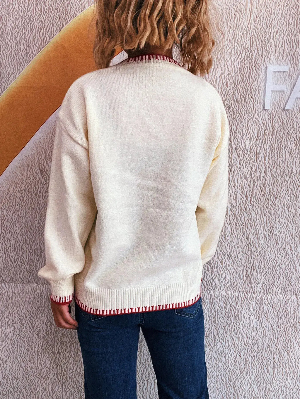 Bow Pattern Round-Neck Sweater in cream with red knit trim at hem and cuffs