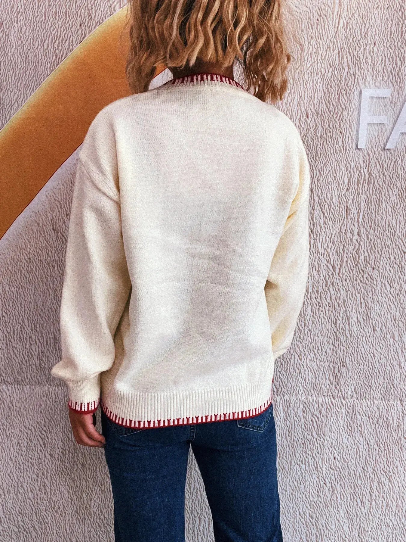 Bow Pattern Round-Neck Sweater in cream with red knit trim at hem and cuffs
