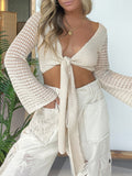 Crochet tie-front cardigan by Trendsi in beige with open-knit long sleeves.