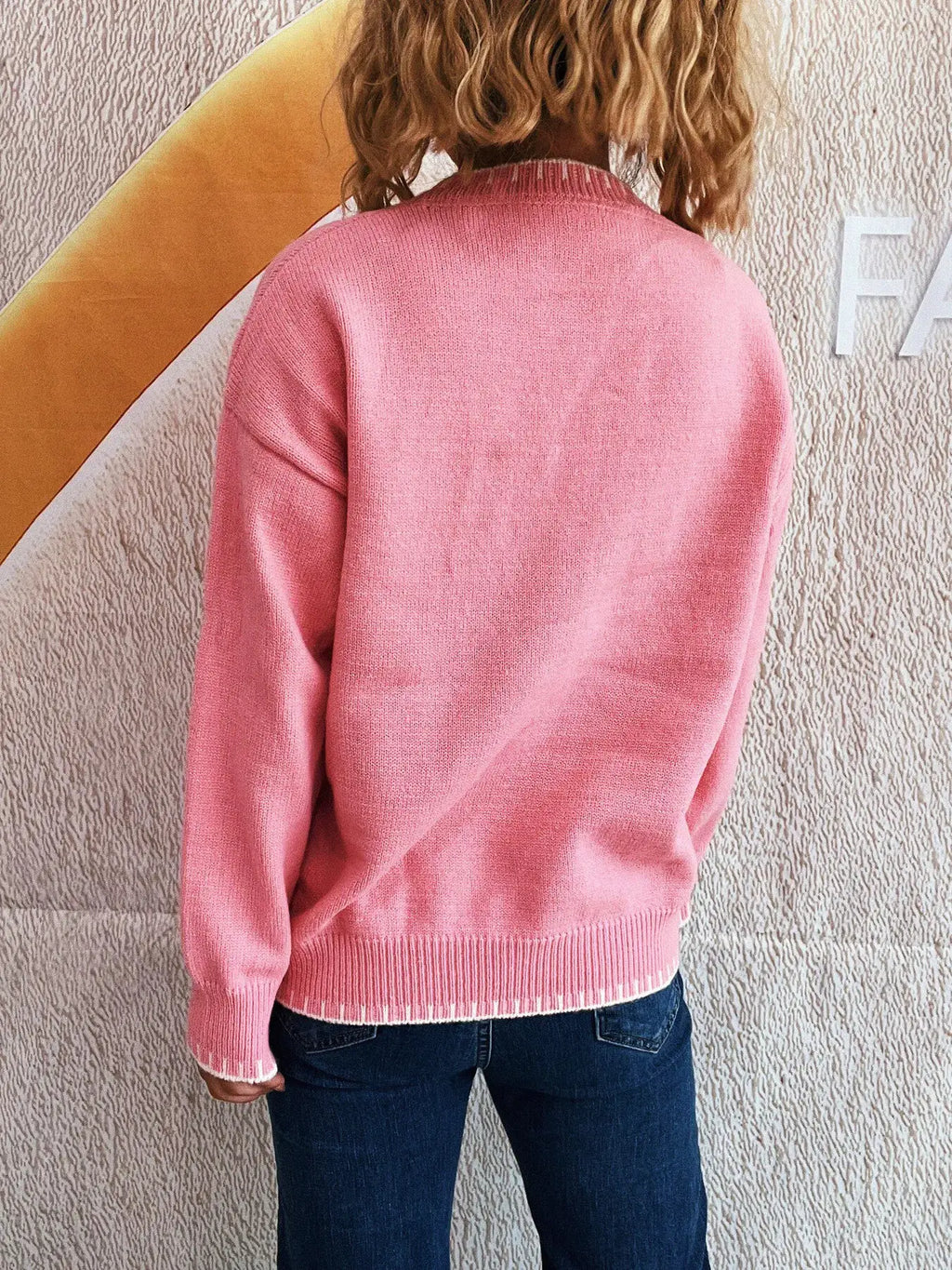 Bow Pattern Round Neck Sweater in pink, shown from the back.