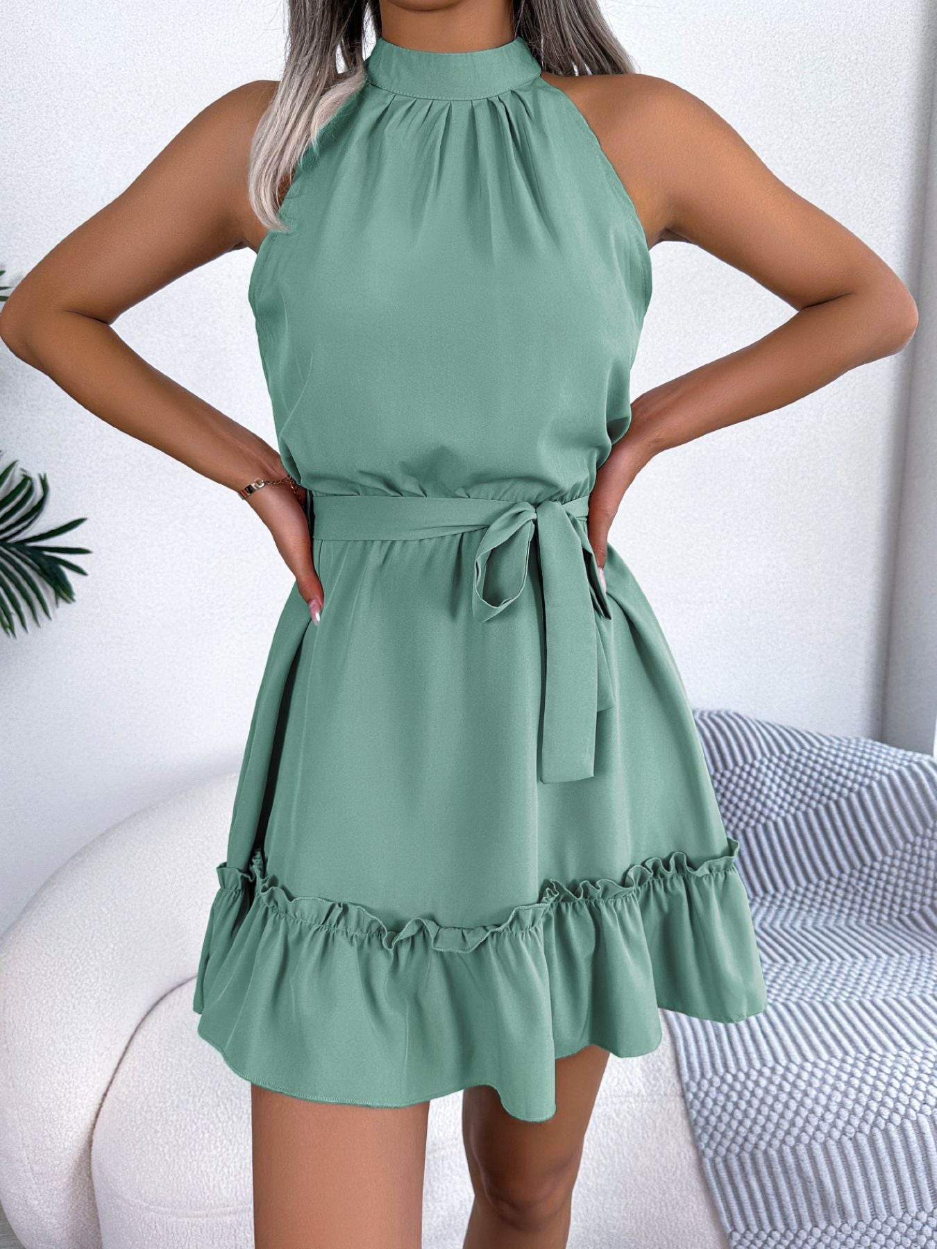 Halter-neck A-line dress in sage green with belt tie and ruffle hem by Belle Bijouix