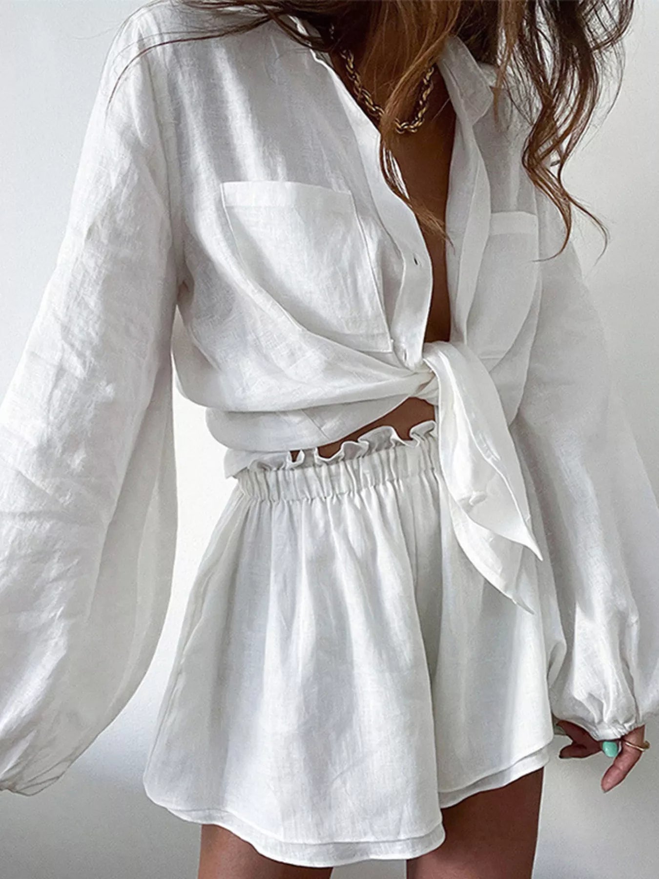 Two-piece white Button Up Long Sleeve Shirt and Shorts Set by Trendsi; tie-front shirt with pockets.