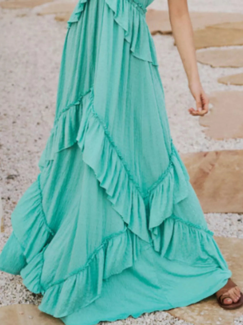 Ruffled halter-neck turquoise maxi dress with cascading tiered ruffles.