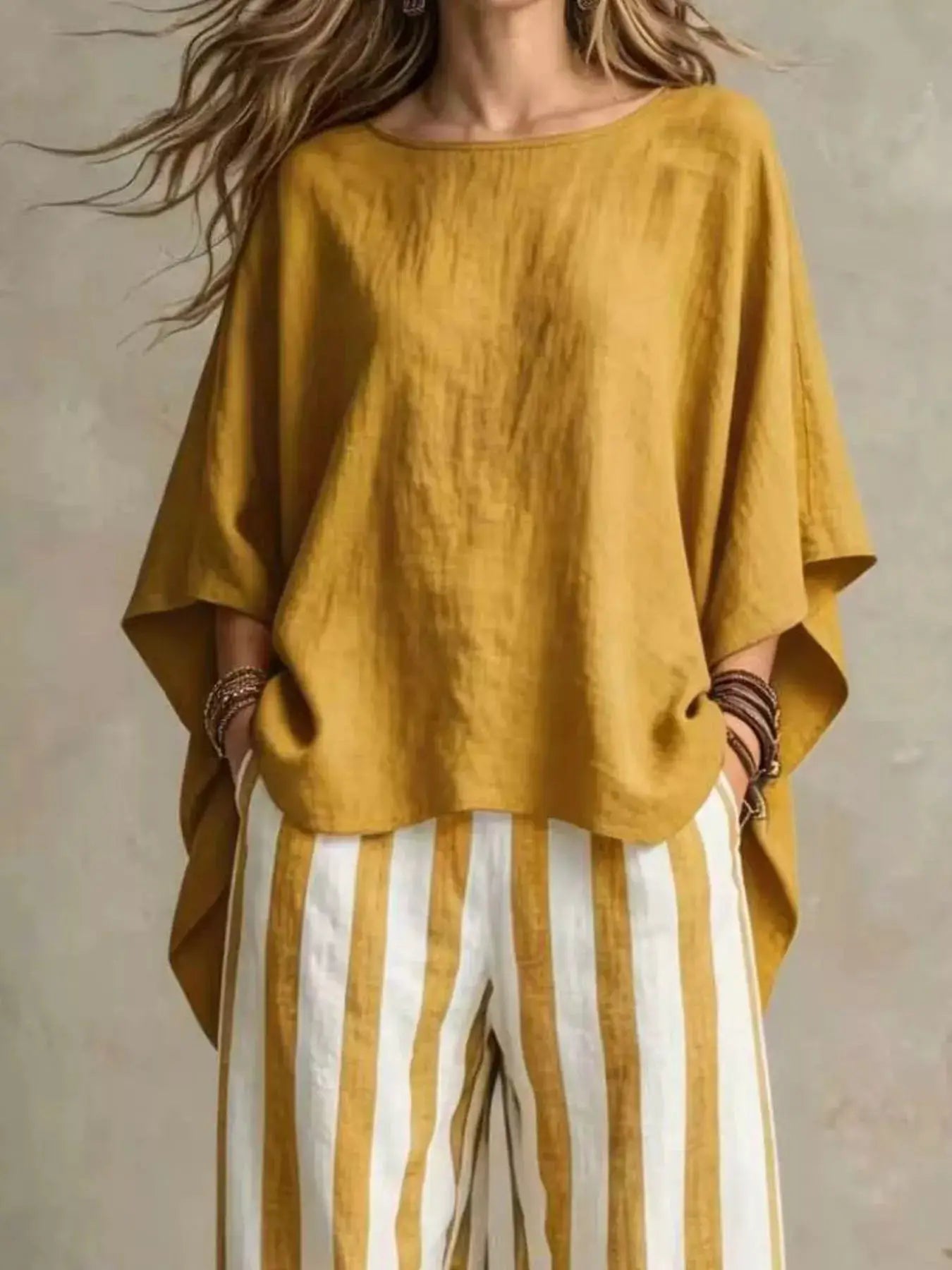 Belle Bijouix plus-size top and pants set in mustard yellow; loose top with wide sleeves and striped pants.