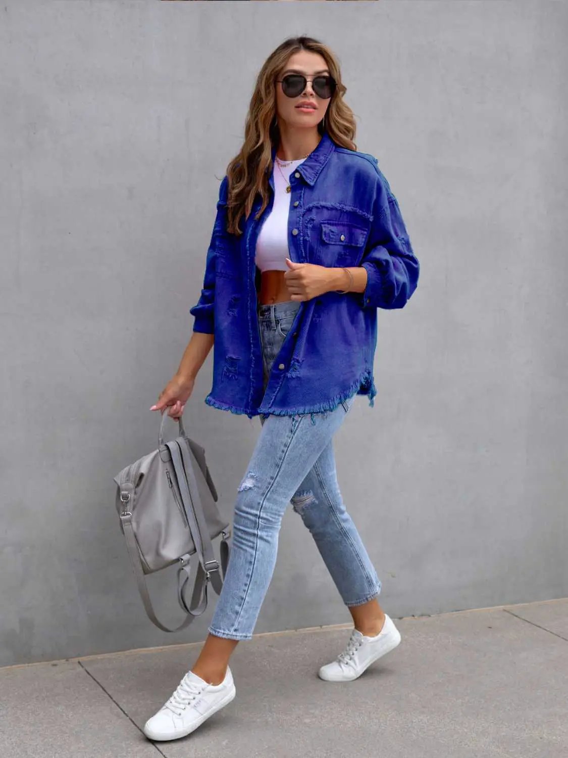 Distressed drop-shoulder denim jacket in blue with frayed hem