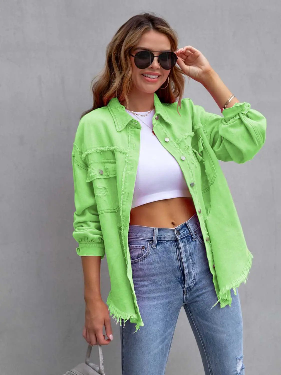 Distressed drop-shoulder denim jacket in lime green with frayed hems; Belle Bijouix.