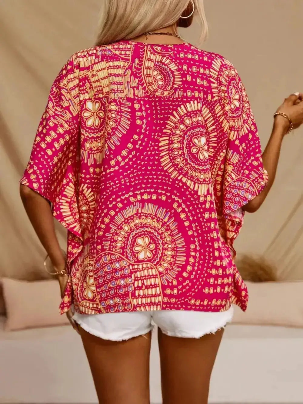 Printed V-Neck Half Sleeve Top in pink with bold circular white pattern; sheer, loose fit.