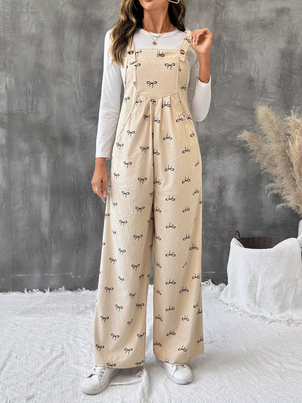 Bow Wide Leg Corduroy Overalls in beige with black bow print, adjustable straps, wide legs