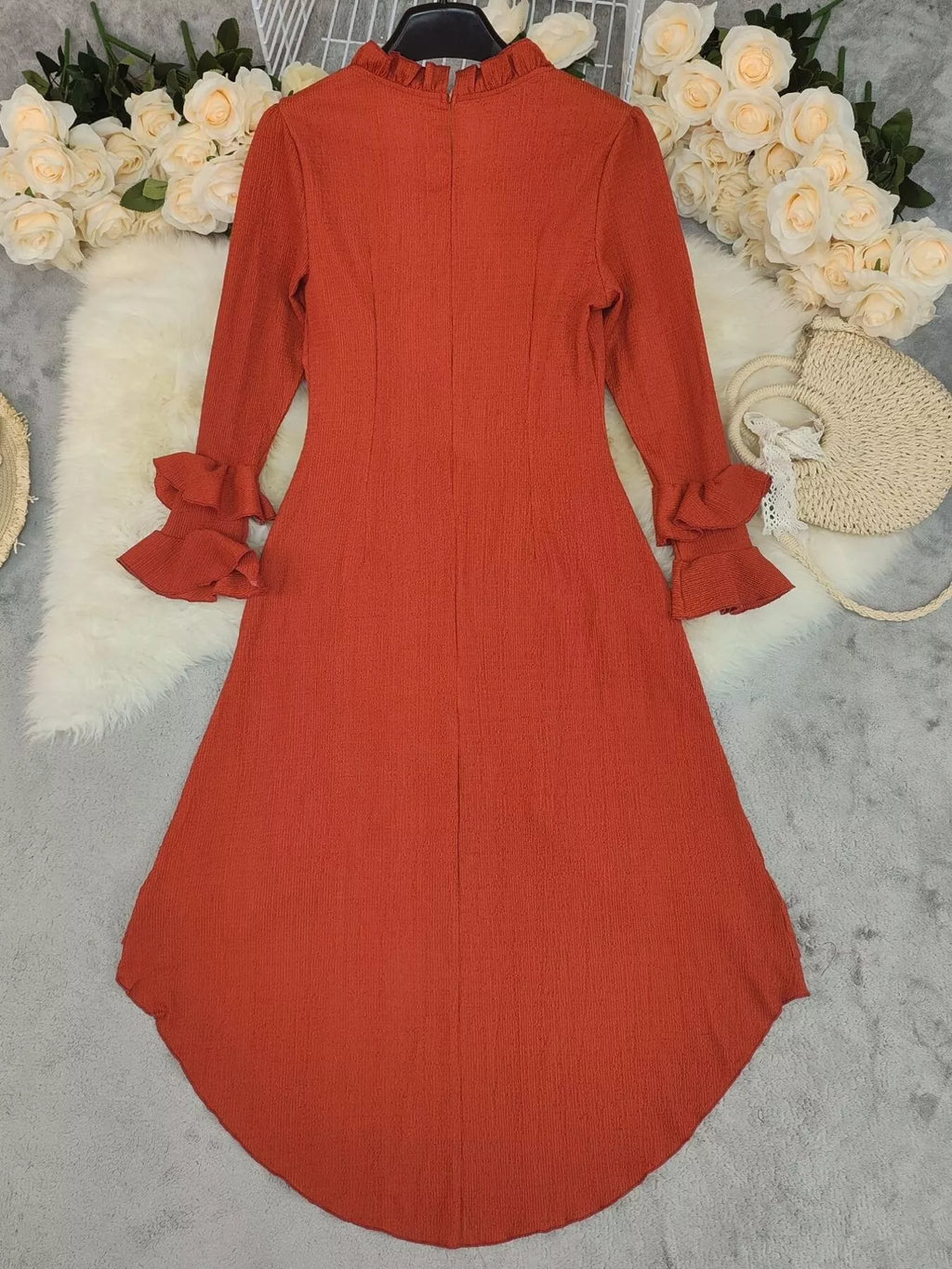 Ruffled High-Low Long Sleeve Dress in rust orange with textured fabric and ruffled cuffs