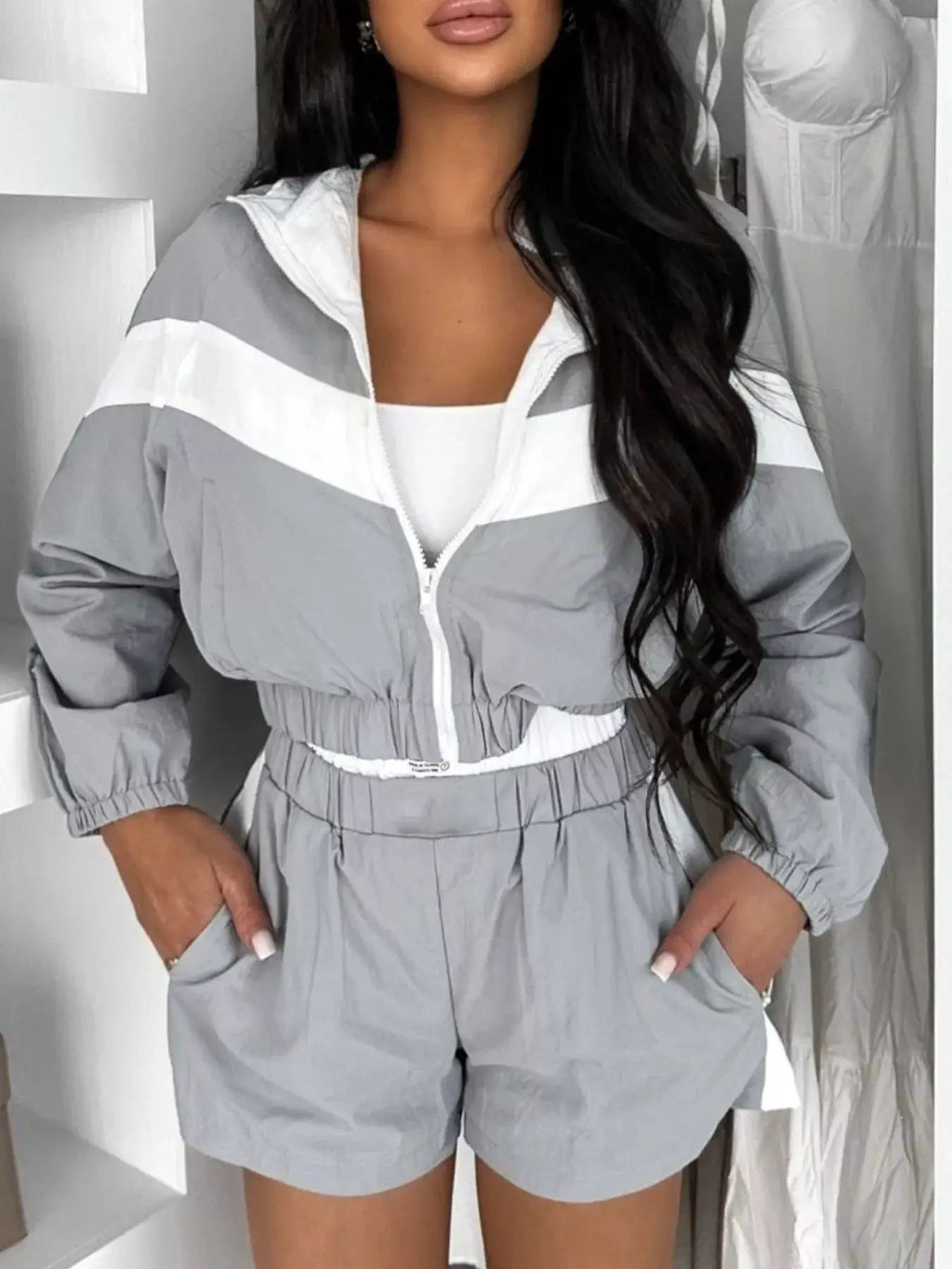 Zip-Up long-sleeve outerwear and shorts two-piece activewear set for women in gray with white stripes.