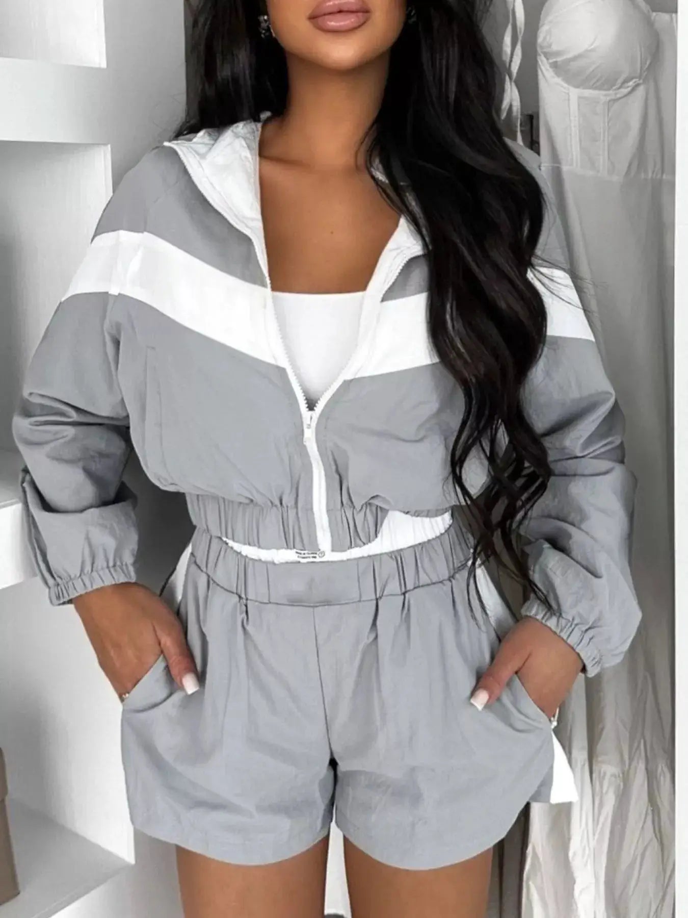 Zip-Up long-sleeve outerwear and shorts two-piece activewear set for women in gray with white stripes.