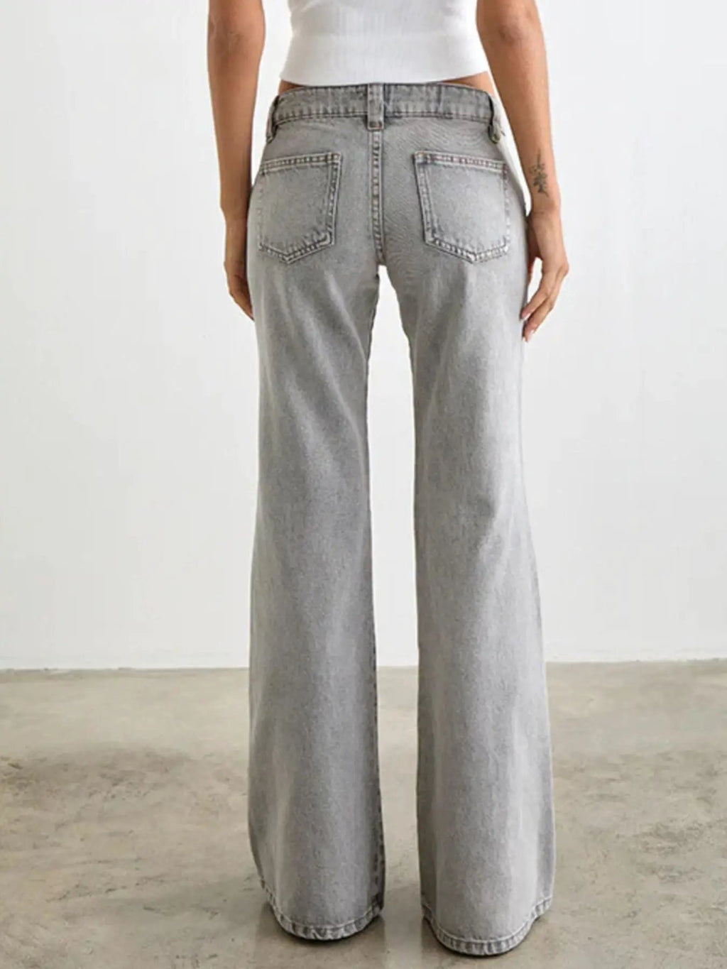 Belle Bijouix Low Rise Flare Leg Jeans in light wash denim with back pockets