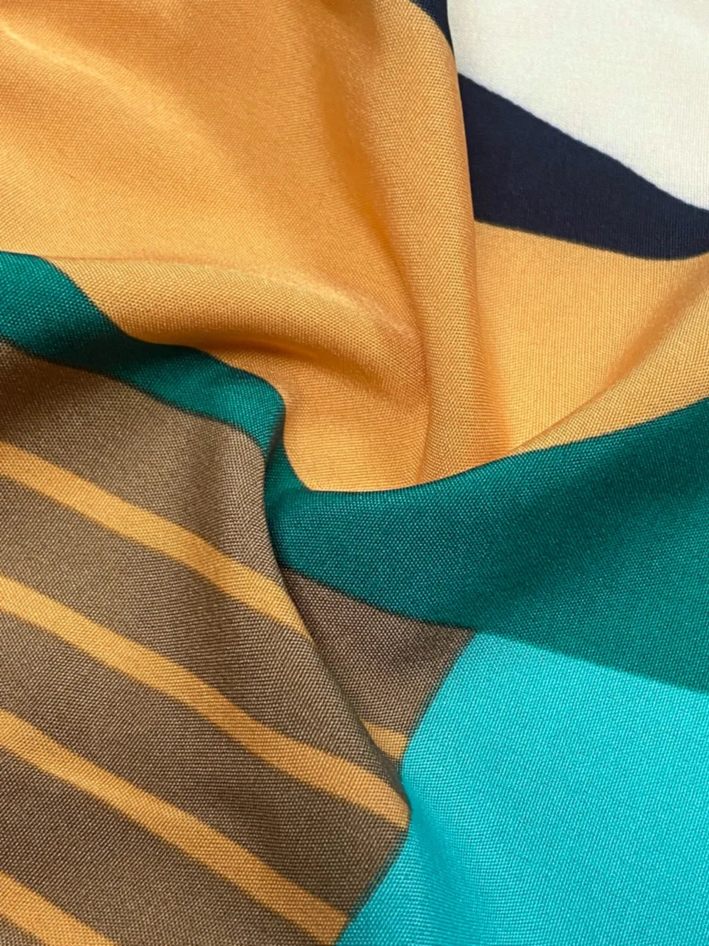 Printed Mock Neck Mini Dress in a teal, mustard yellow, and brown striped print by Belle Bijouix.
